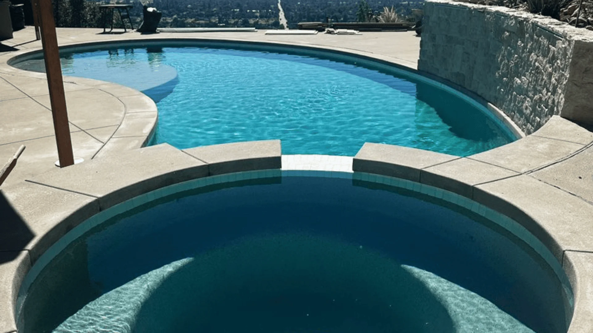 Landscape contractor installing outdoor lighting and landscaping around residential property